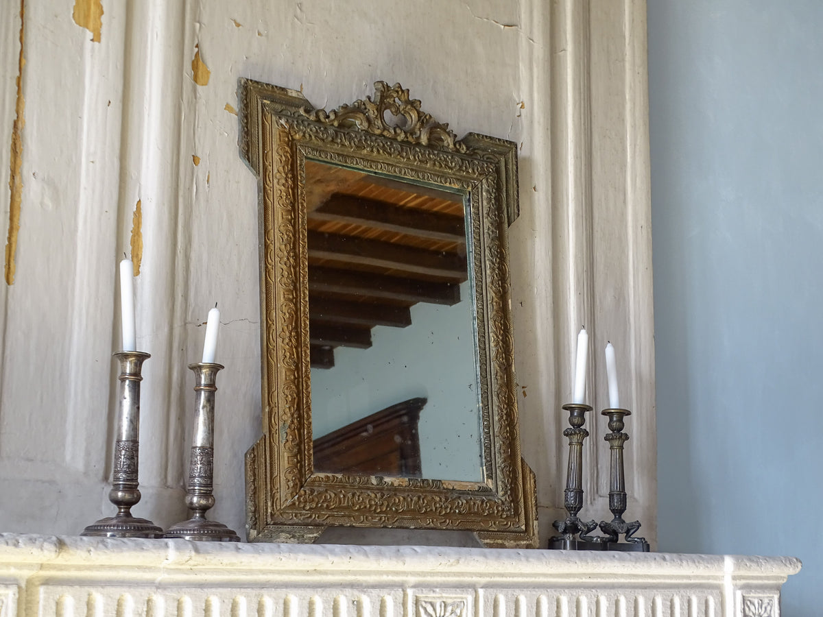 French antique giltwood and stucco mirror with ornate 19th-century frame and aged mirror plate