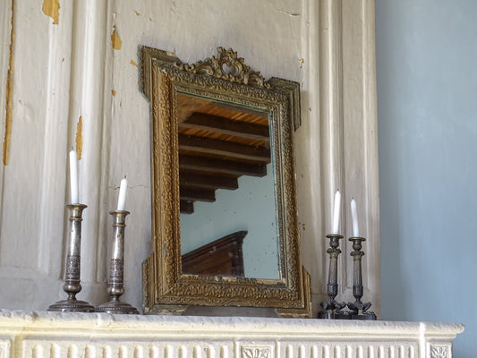 French antique giltwood and stucco mirror with ornate 19th-century frame and aged mirror plate