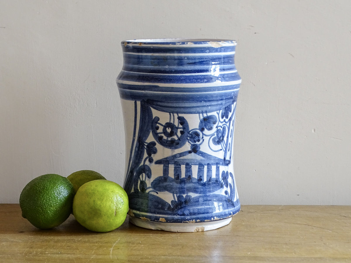 19th-century Spanish blue and white albarello styled with fresh limes