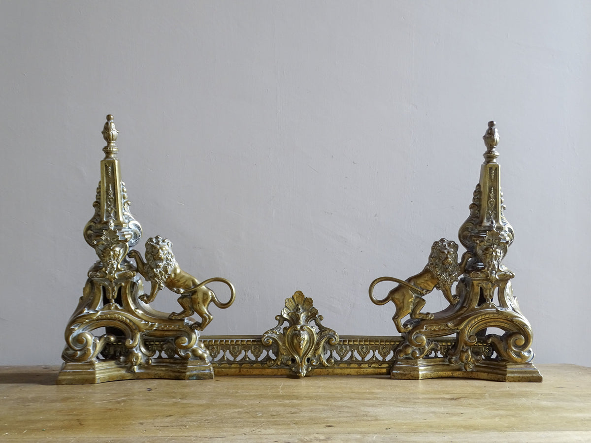 19th century French brass fireplace fender with opposing lion figures and ornate decoration