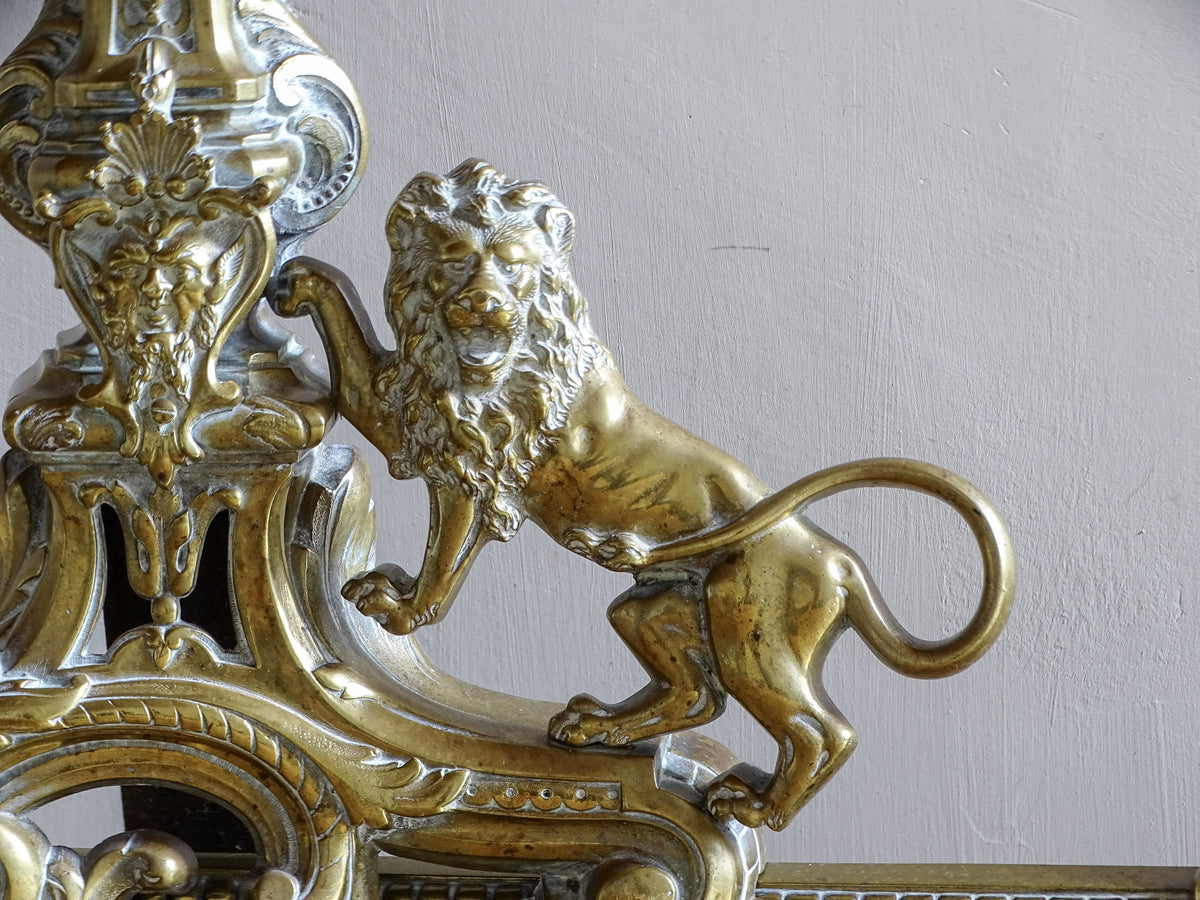 Cast brass lion detail on a 19th century French fireplace fender