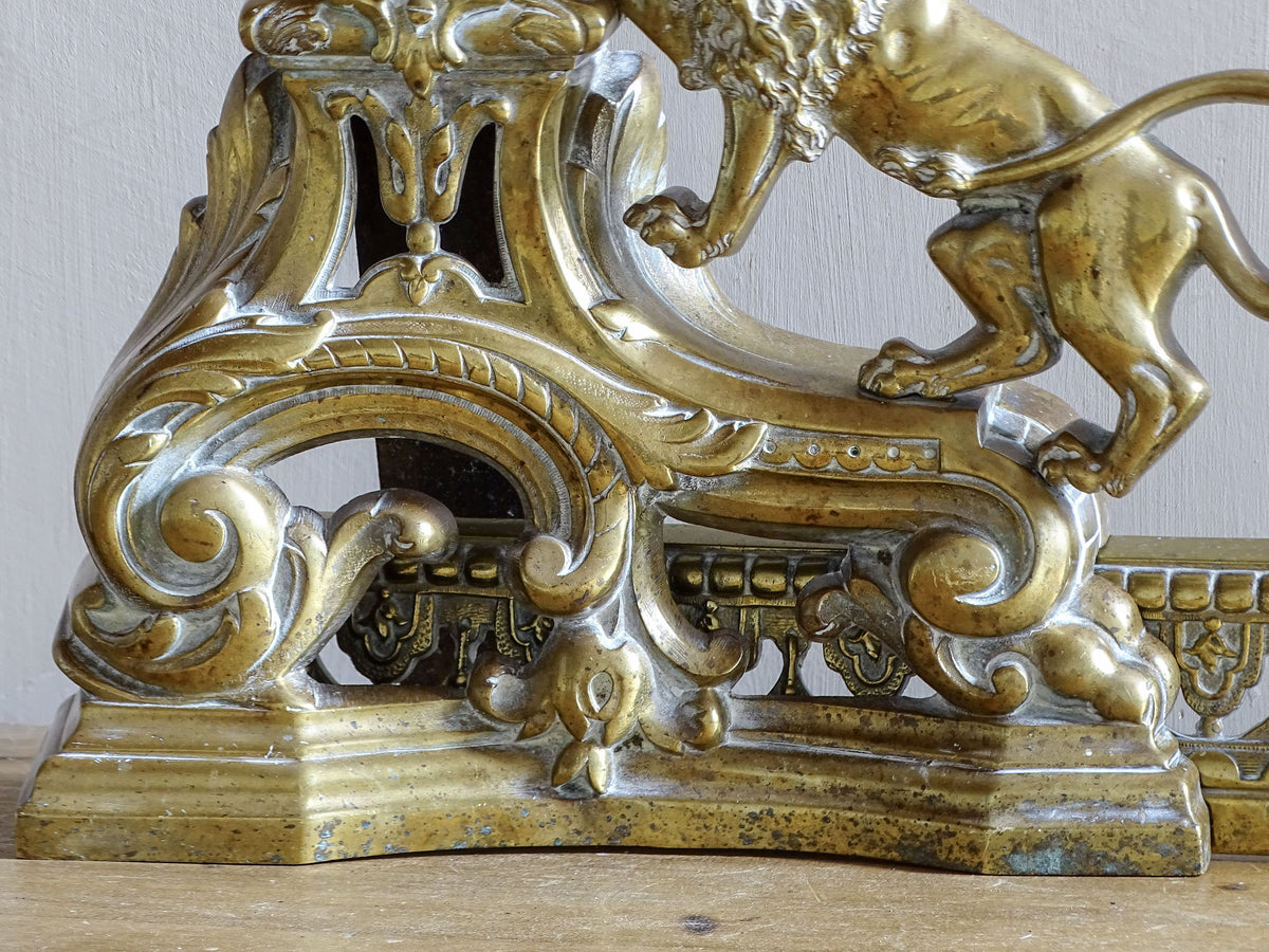 Detailed cast brass scrollwork and ornament on an antique French fireplace fender