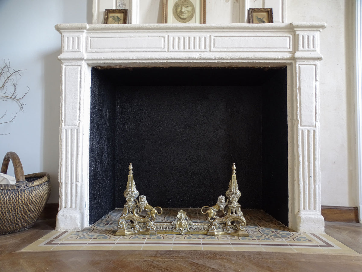 French Napoleon III brass fireplace fender with lions positioned in front of a fireplace