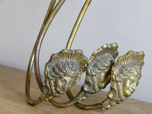 Set of three antique French gilt curtain holdbacks with long curved arms and female masks
