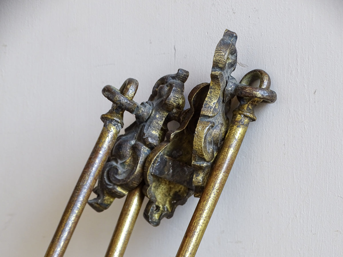 Reverse view of antique French curtain holdbacks showing original wall mounting fittings