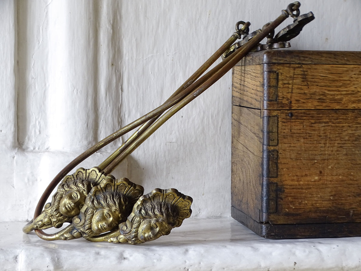  Three French antique gilt metal curtain holdbacks with classical female mask decoration