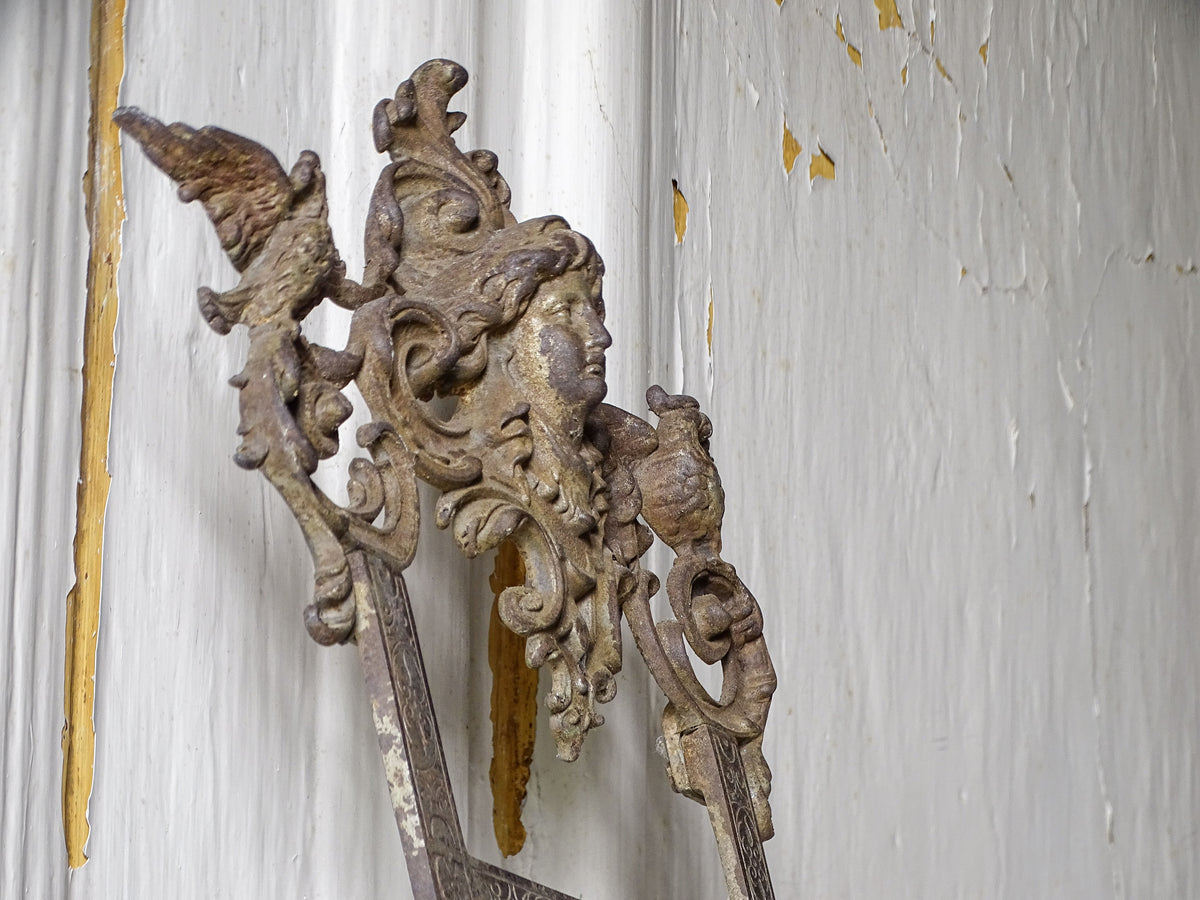 Side view of an ornate 19th-century German cast iron display easel with decorative scrollwork and folding support