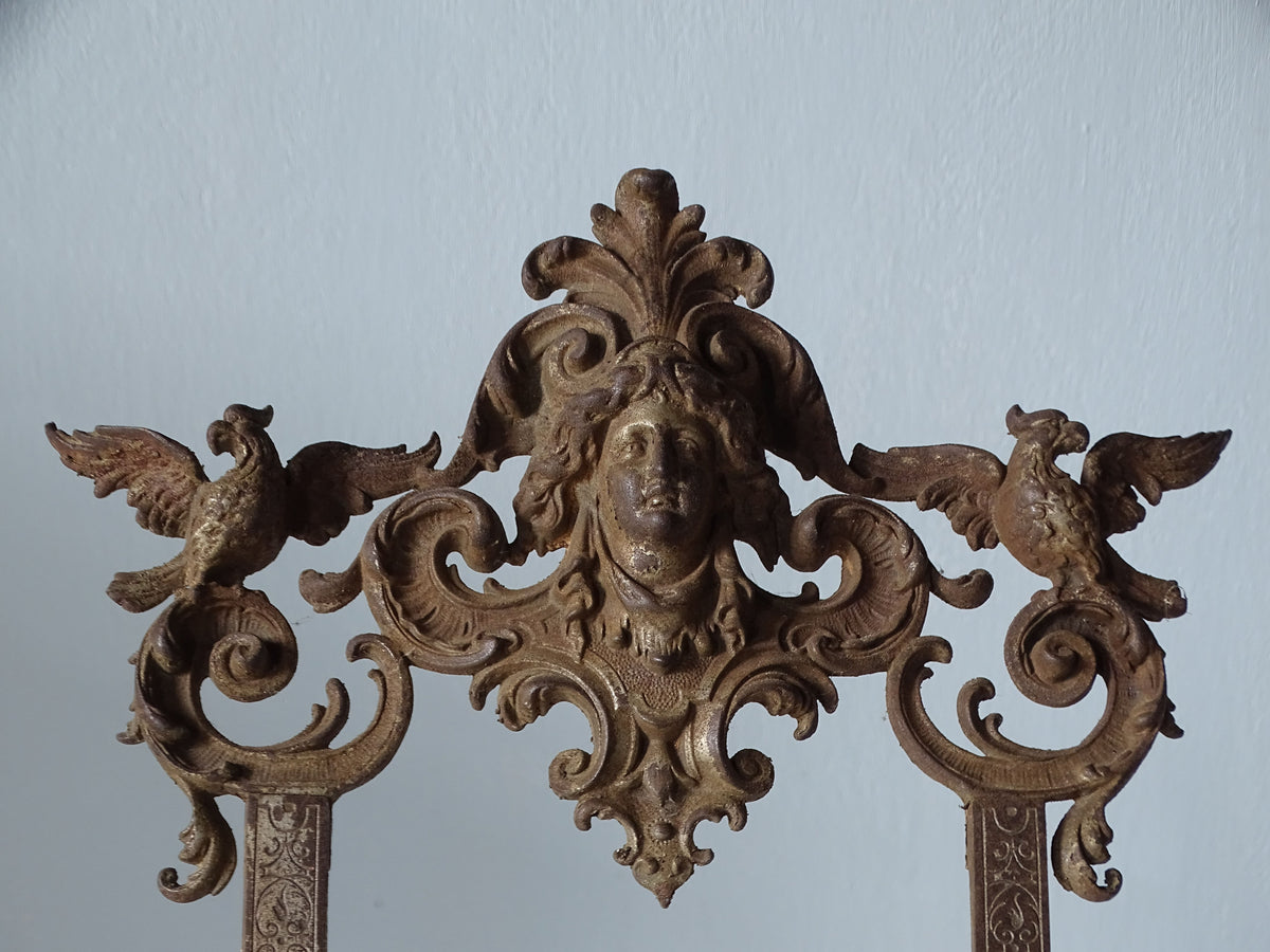 Ornate crest of an antique cast iron easel by E.G. Zimmermann, with classical female portrait and symmetrical bird decoration