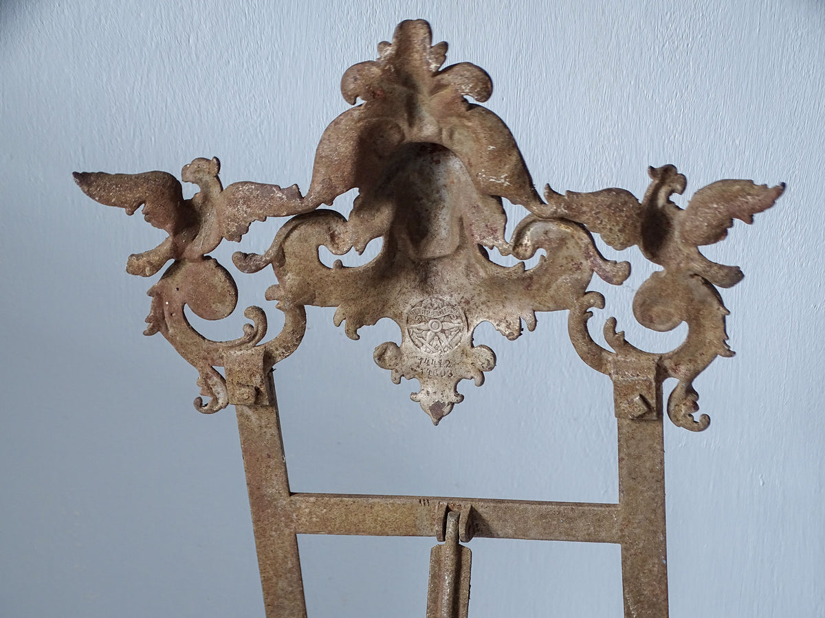 Close-up of the Carpe Diem foundry trademark stamped on the reverse of an antique E.G. Zimmermann cast iron easel.
