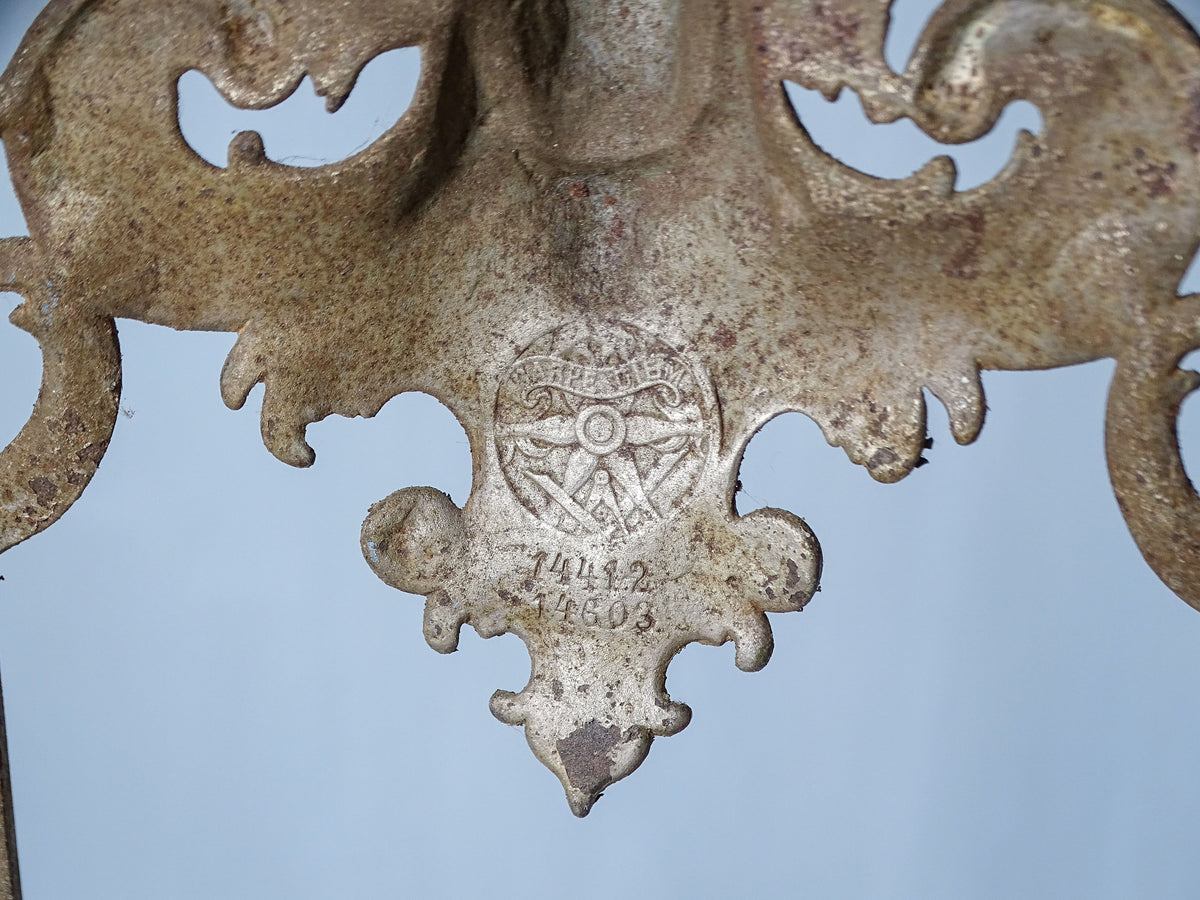 Close-up of the Carpe Diem foundry trademark stamped on the reverse of an antique E.G. Zimmermann cast iron easel