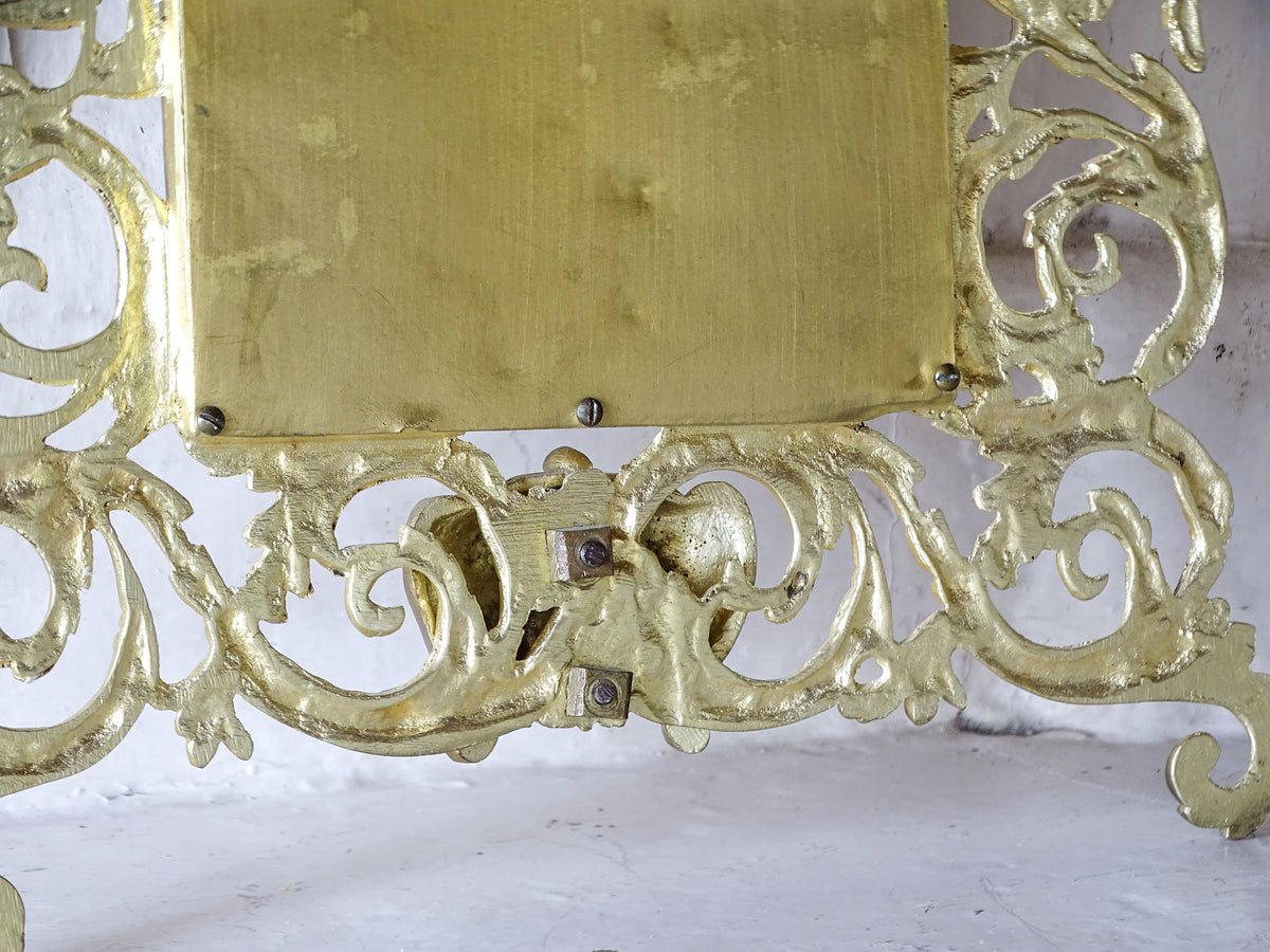 Reverse of the Napoleon III mirror showing the cast classical face and intricate scrolling foliage