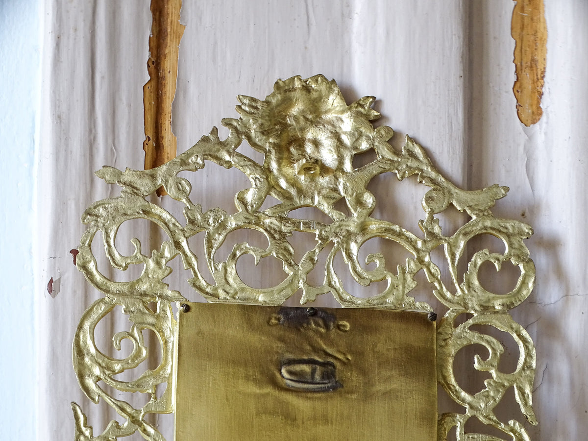Close-up of the reverse of a French Napoleon III gilt metal mirror showing the openwork casting and decorative scrolls