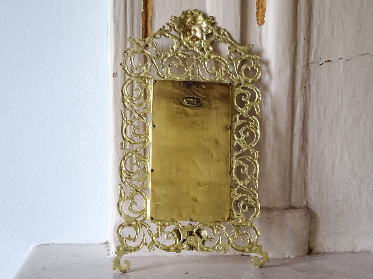 Full reverse view of the French antique gilt metal wall mirror showing its backing plate and hanging fitting