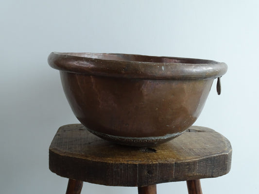 Antique French Copper Confectioner's or Mixing Bowl from the 18th Century. This timeworn copper bowl has a rolled top and copper rivets to the curved base. 