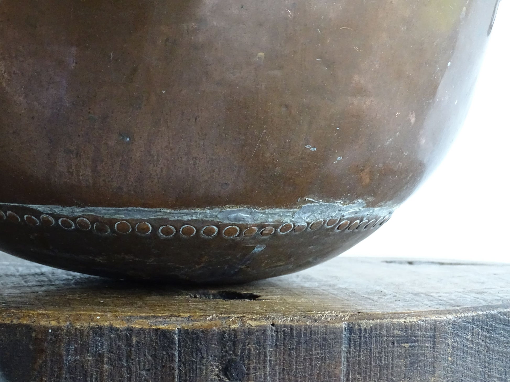 Antique French Copper Confectioner's or Mixing Bowl from the 18th Century. This timeworn copper bowl has a rolled top and copper rivets to the curved base.