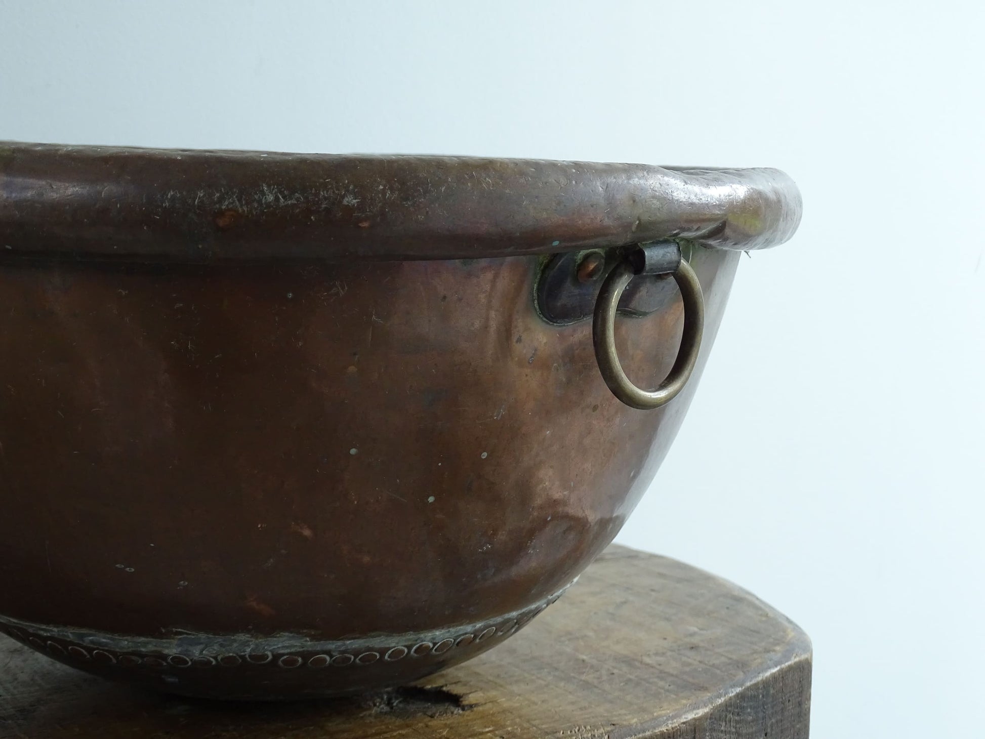 Antique French Copper Confectioner's or Mixing Bowl from the 18th Century. This timeworn copper bowl has a rolled top and copper rivets to the curved base.