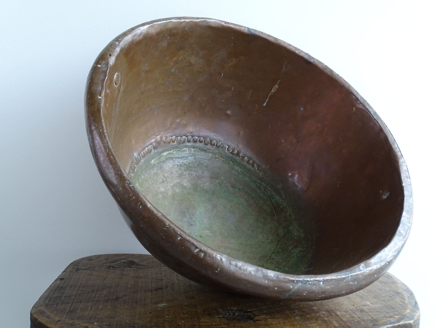 Antique French Copper Confectioner's or Mixing Bowl from the 18th Century. This timeworn copper bowl has a rolled top and copper rivets to the curved base.