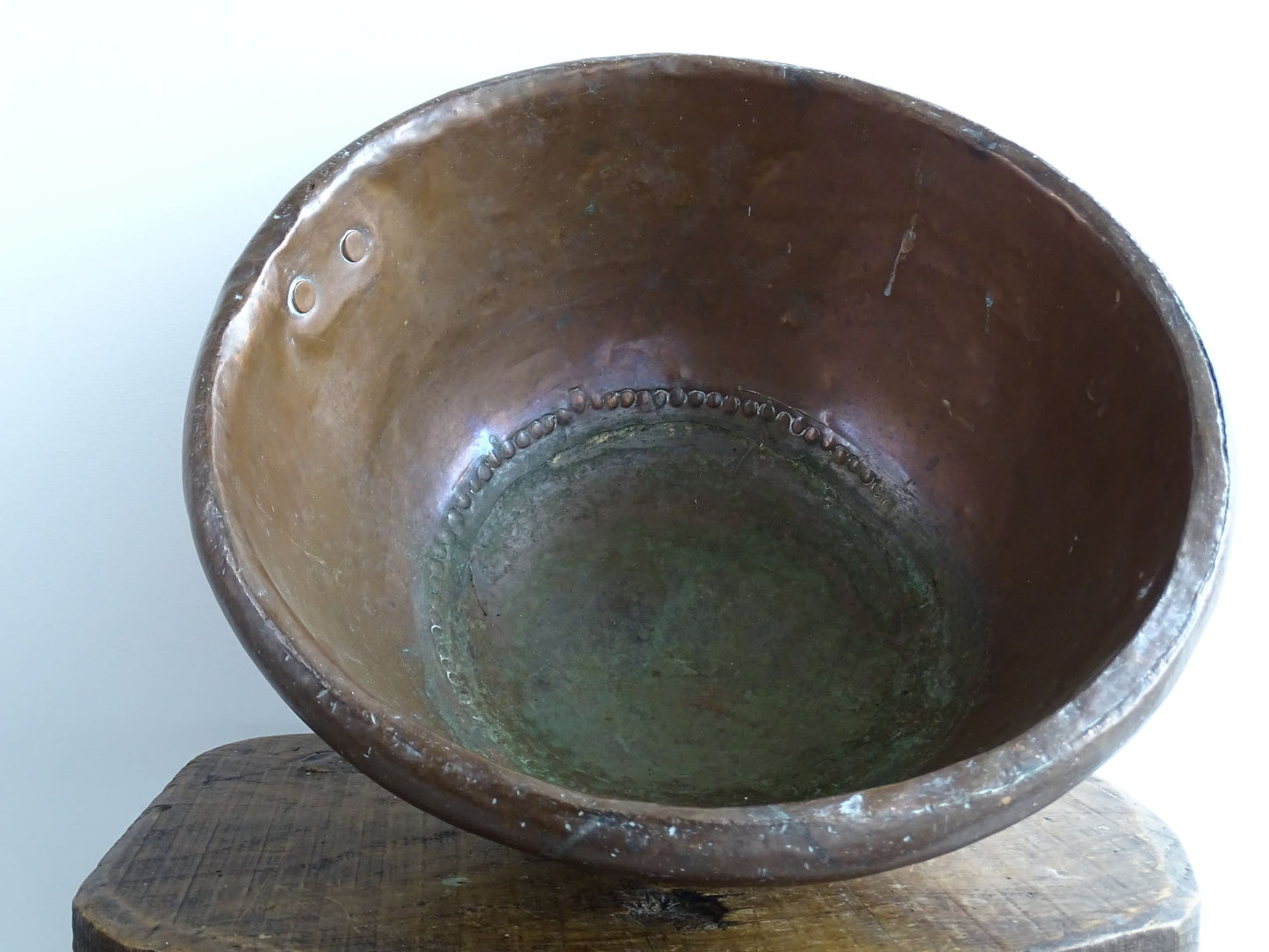 Antique French Copper Confectioner's or Mixing Bowl from the 18th Century. This timeworn copper bowl has a rolled top and copper rivets to the curved base.