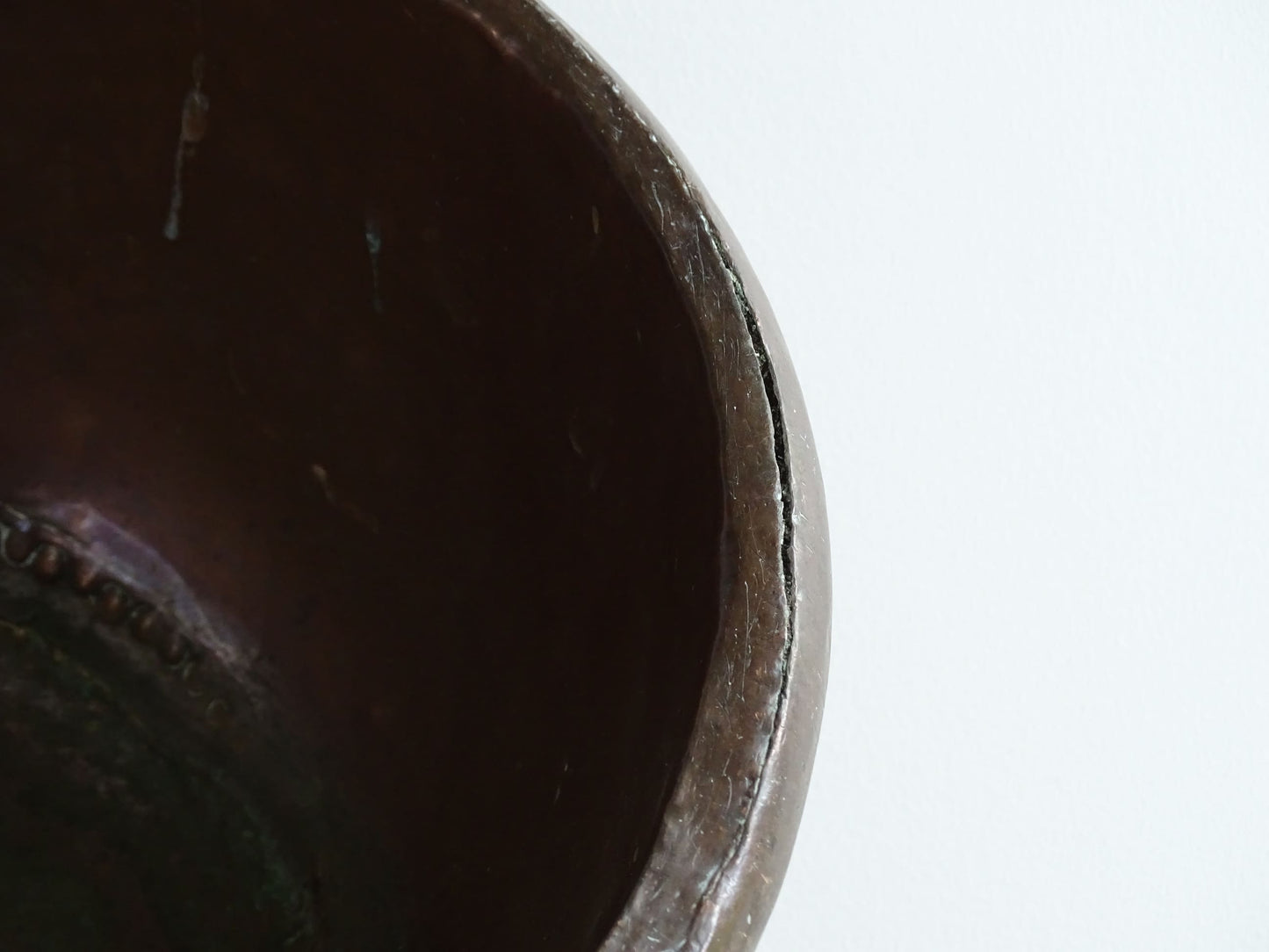 Antique French Copper Confectioner's or Mixing Bowl from the 18th Century. This timeworn copper bowl has a rolled top and copper rivets to the curved base.