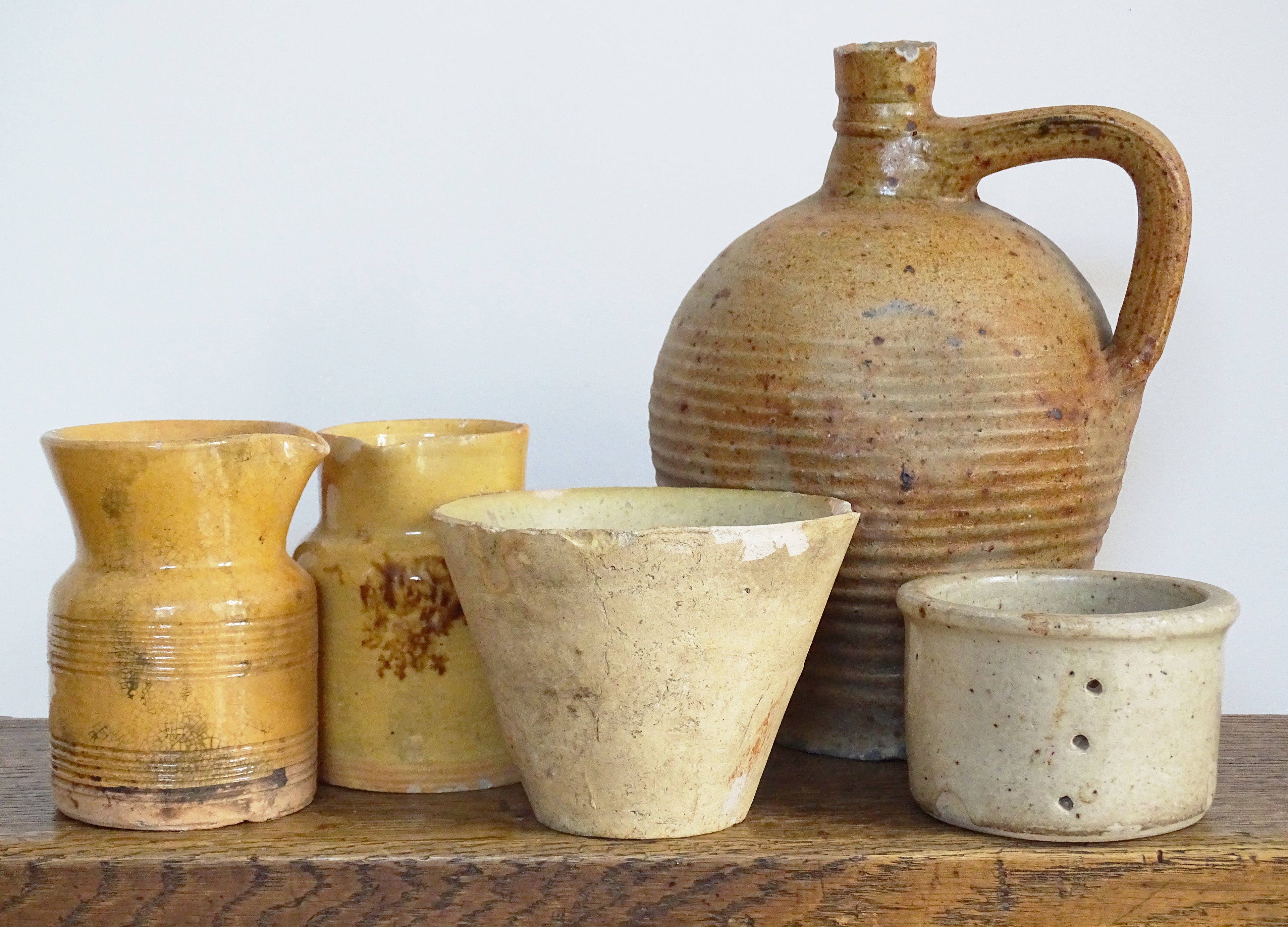 Antique French pottery collection, glazed yellow pottery jugs, earthenware bowls and pitchers. 