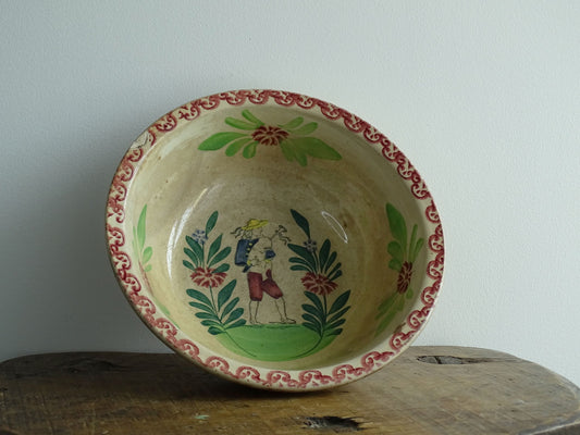 Antique Saint Amand Salad Bowl with Figure of a man and foliage and flower decoration