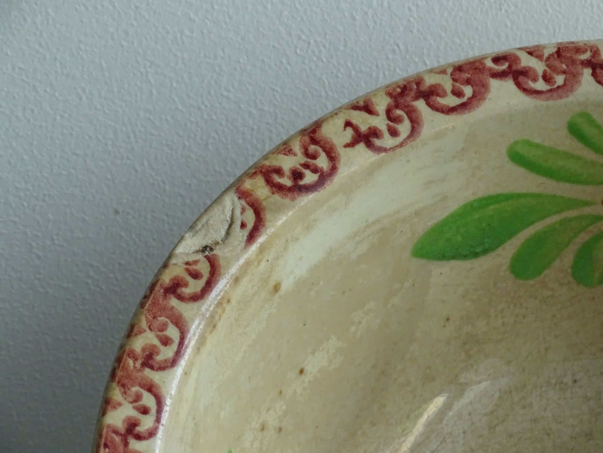 Antique Saint Amand Salad Bowl with Figure of a man and foliage and flower decoration