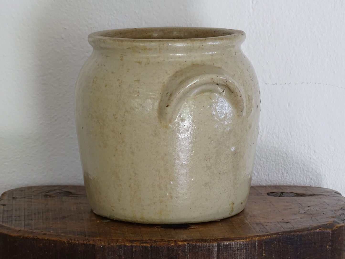 Antique French stoneware confit pot or preserving pot glazed in a pale oatmeal or sand colour. This crock pot or cache pot has two curved handles to each side.