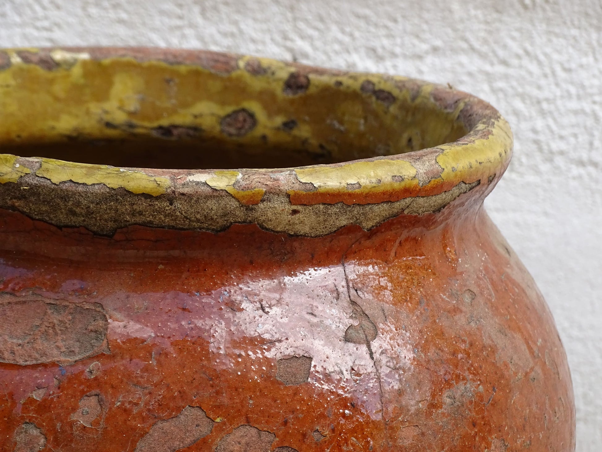 Antique French terracotta pot with brown and yellow glaze. Antique pottery pot for a rustic display.