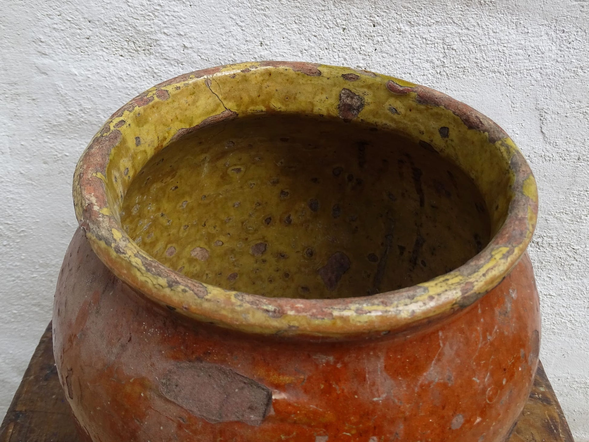 Antique French terracotta pot with brown and yellow glaze. Antique pottery pot for a rustic display.