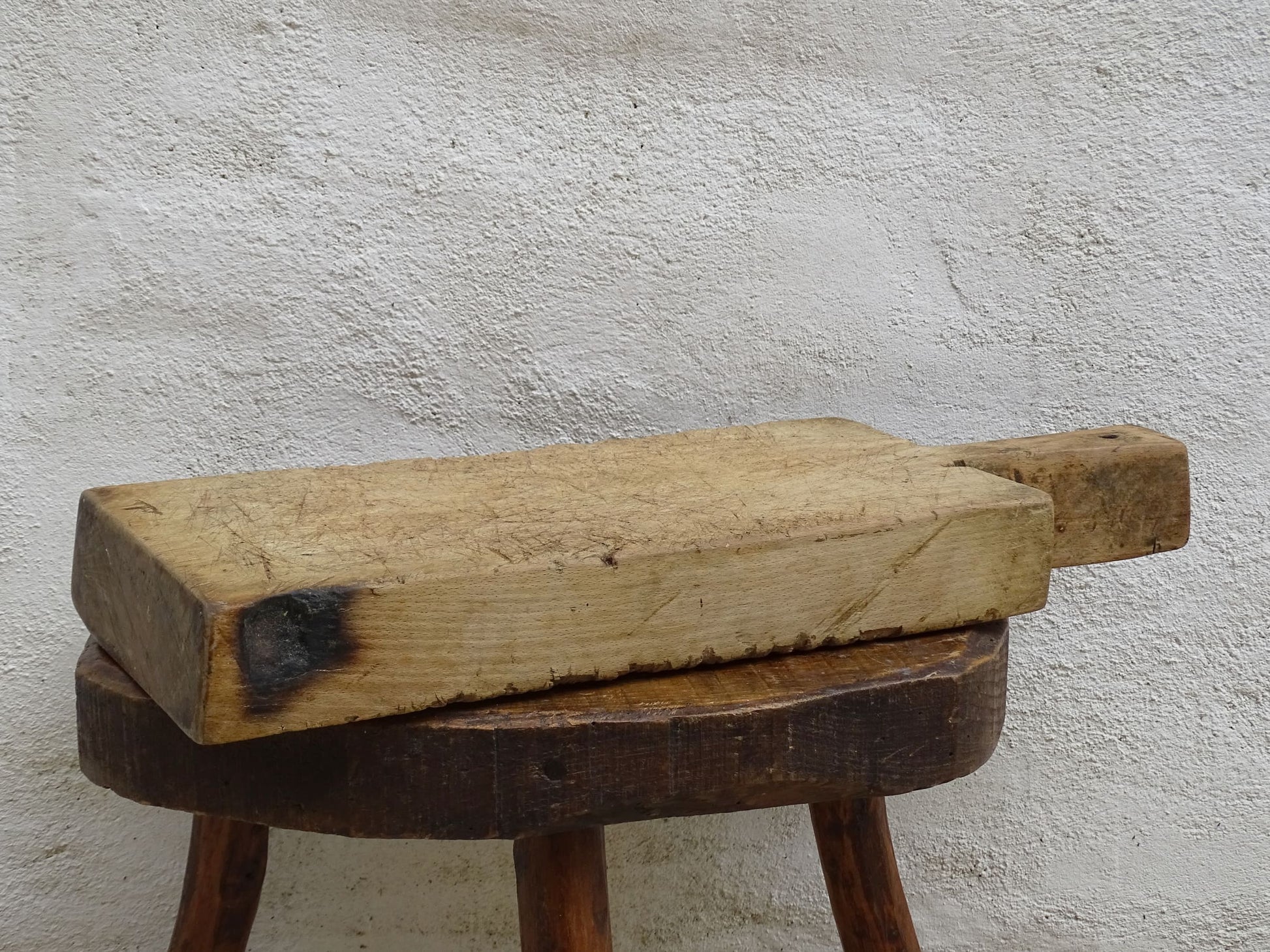 Rustic French antique wooden chopping board with a long handle. Cutting board for a French farmhouse style kitchen