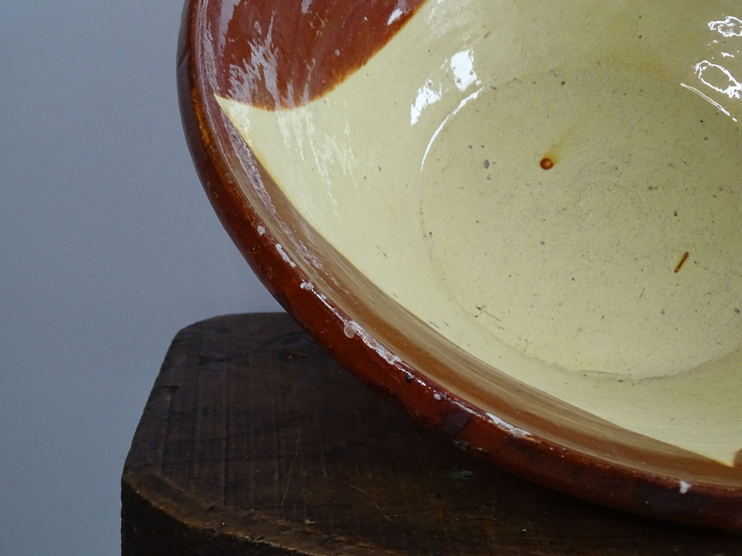 Antique Spanish terracotta bowl or basin with a brown and yellow glaze to the interior. This pottery bowl has a timeworn patina.