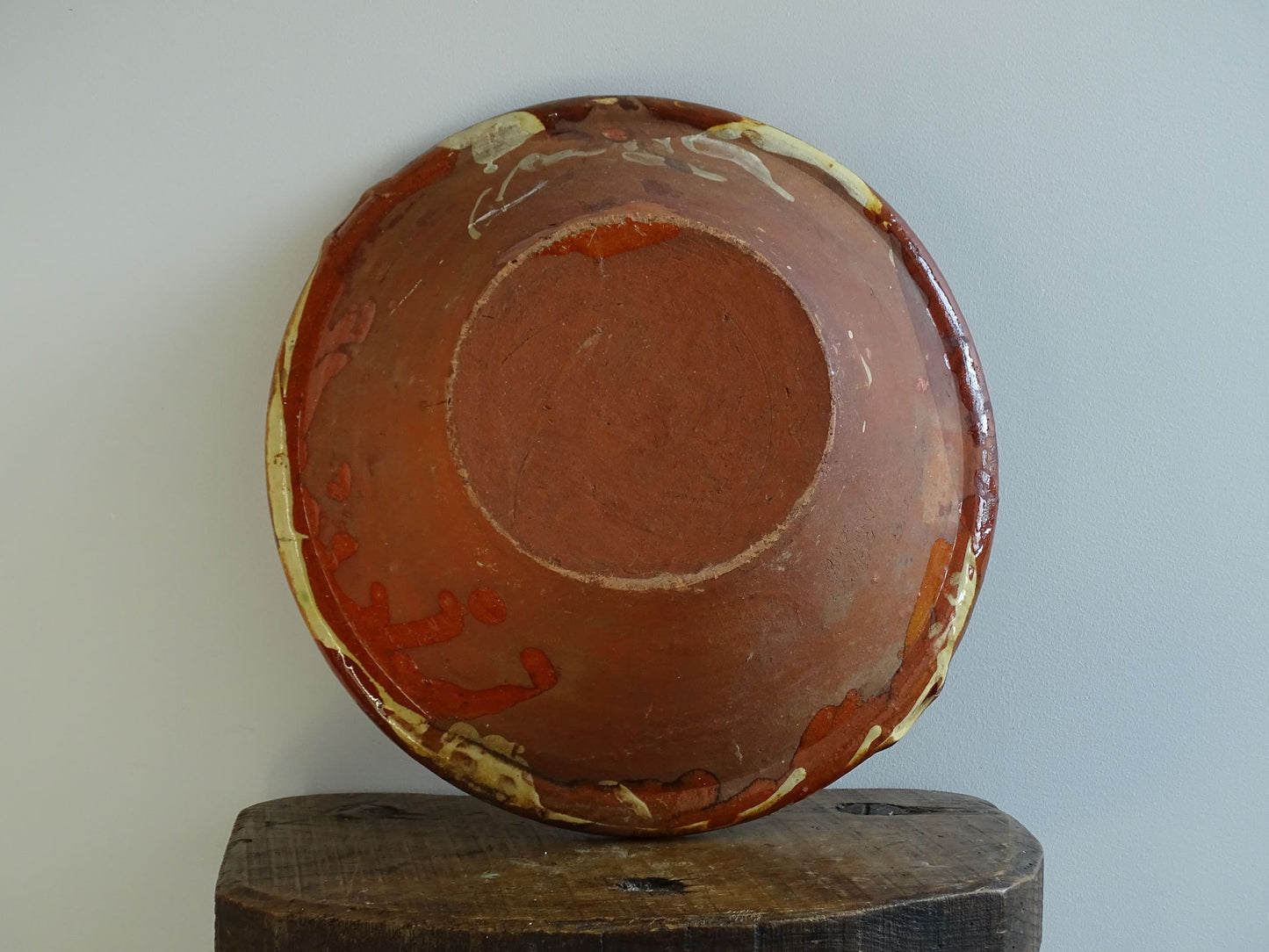 Antique Spanish terracotta bowl or basin with a brown and yellow glaze to the interior. This pottery bowl has a timeworn patina.