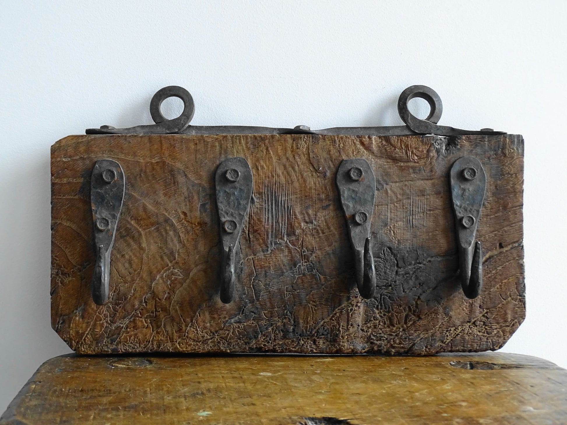 Antique Wrought Iron Hooks on Aged Wood for a French country farmhouse kitchen decor.