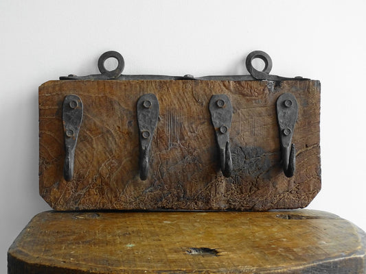 Antique Wrought Iron Hooks on Aged Wood for a French country farmhouse kitchen decor.