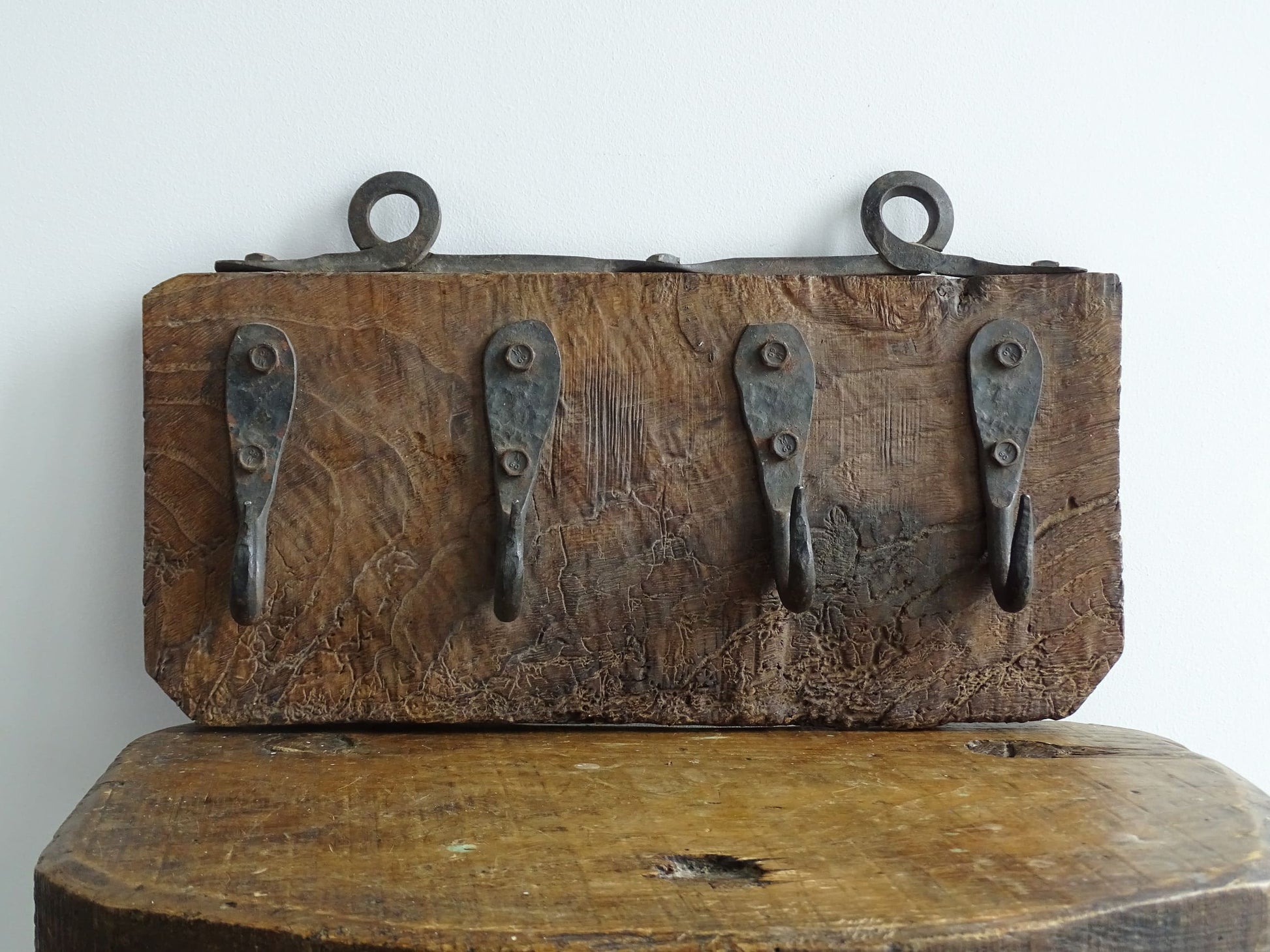 Antique Wrought Iron Hooks on Aged Wood for a French country farmhouse kitchen decor.