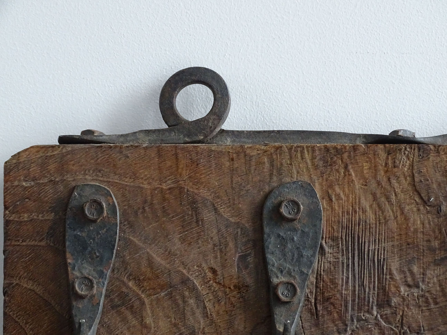 Antique Wrought Iron Hooks on Aged Wood for a French country farmhouse kitchen decor.