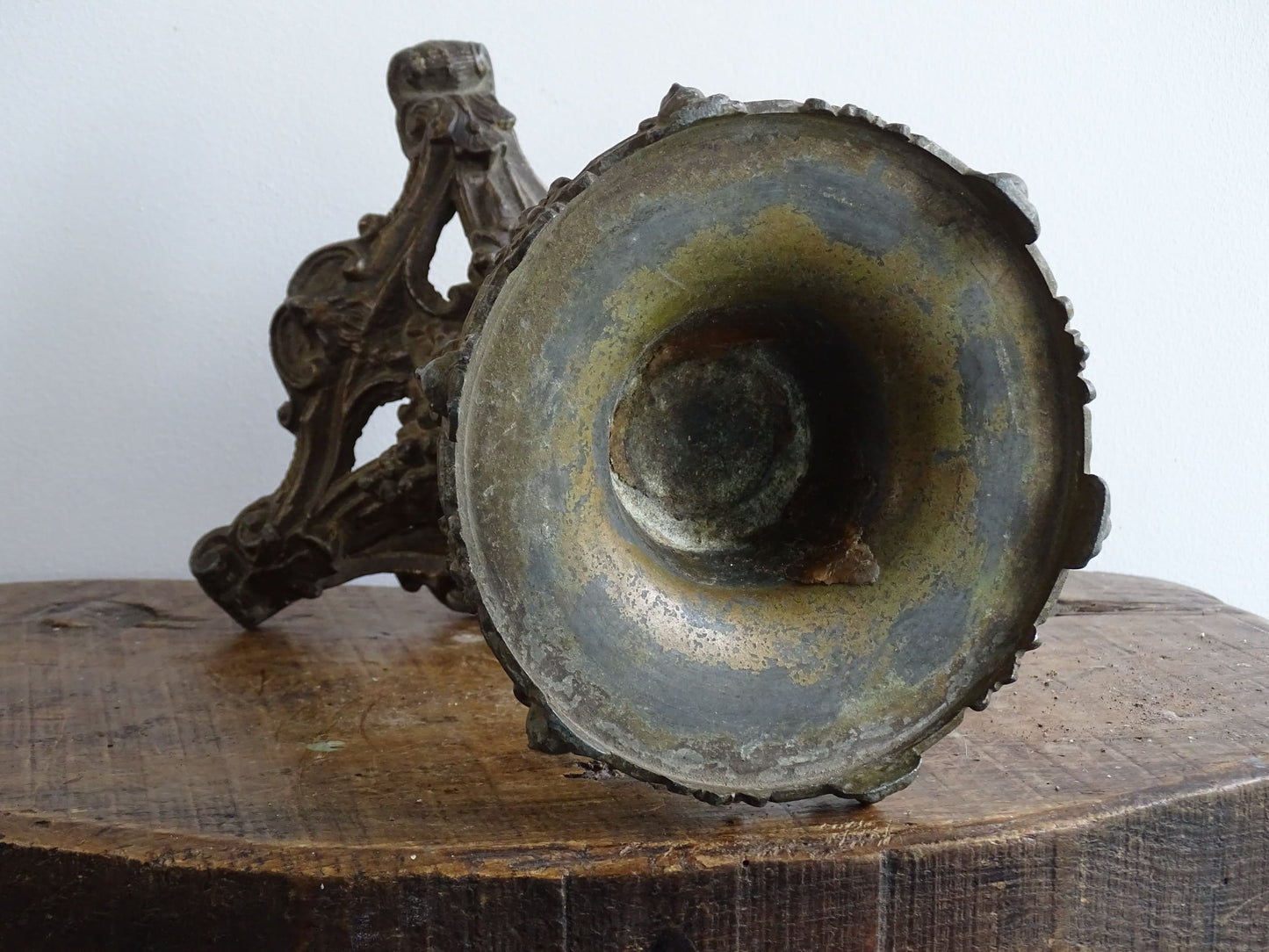 Ornate French antique cast iron candle holder with tripod base and decorated with cherubs. 