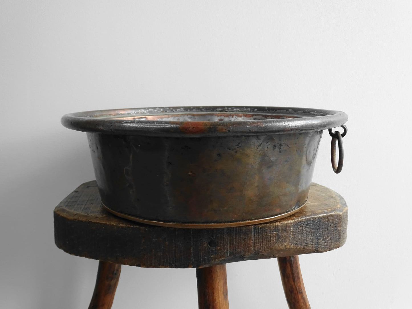 French antique copper mixing bowl with rolled top and handle. Copper bowl with timeworn appearance for a French country farmhouse kitchen.