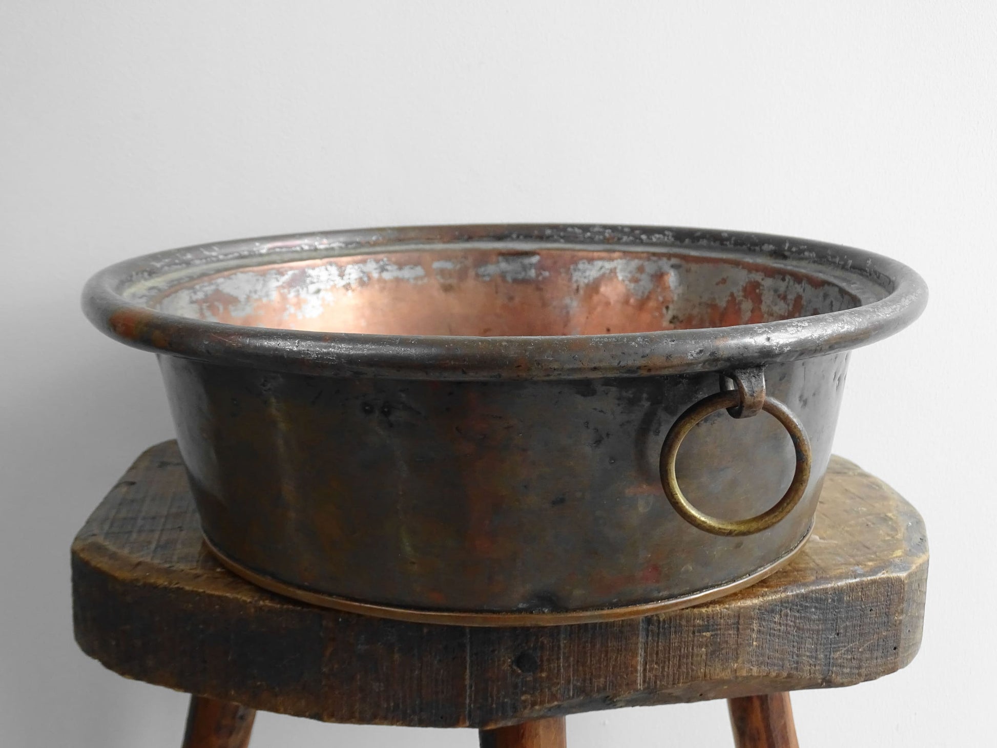 French antique copper mixing bowl with rolled top and handle. Copper bowl with timeworn appearance for a French country farmhouse kitchen.