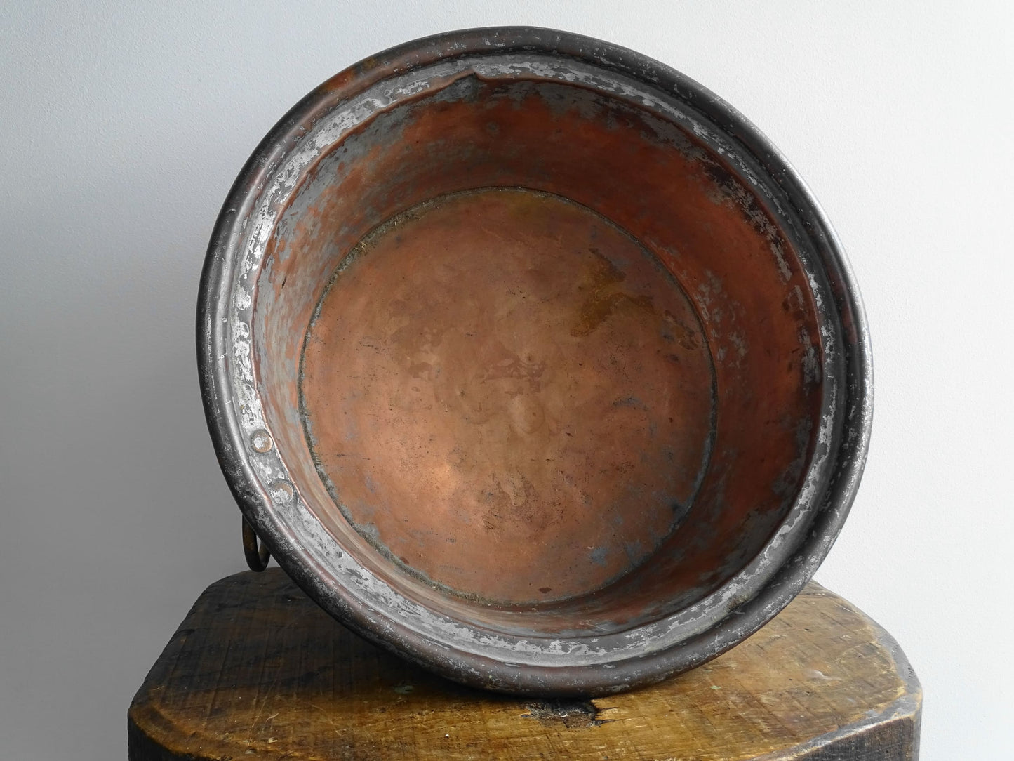 French antique copper mixing bowl with rolled top and handle. Copper bowl with timeworn appearance for a French country farmhouse kitchen.