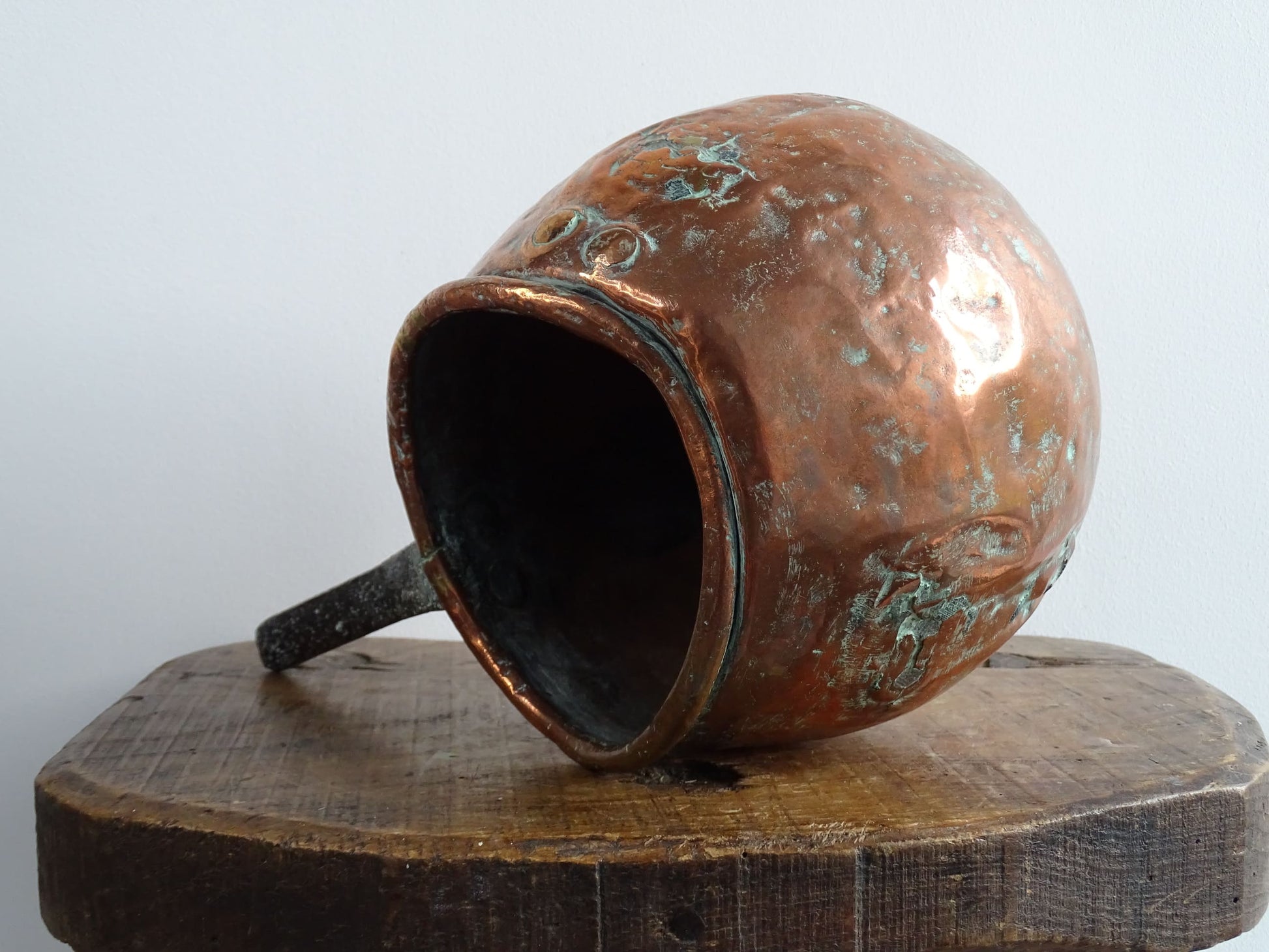 French antique copper zabaglione pan with a curved base, rustic dents, and a rich patina, ideal as a copper kitchen accent in a French farmhouse kitchen, displayed hanging or on a shelf alongside vintage cookware.