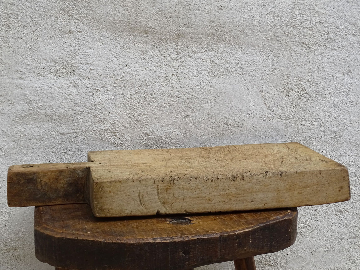 Rustic French antique wooden chopping board with a long handle. Cutting board for a French farmhouse style kitchen