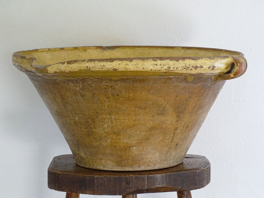 Extra large antique french 19th century terracotta tian bowl with yellow glaze. This big, timeworn, earthenware gresale or basin has a beautiful aged apperance with patina. 