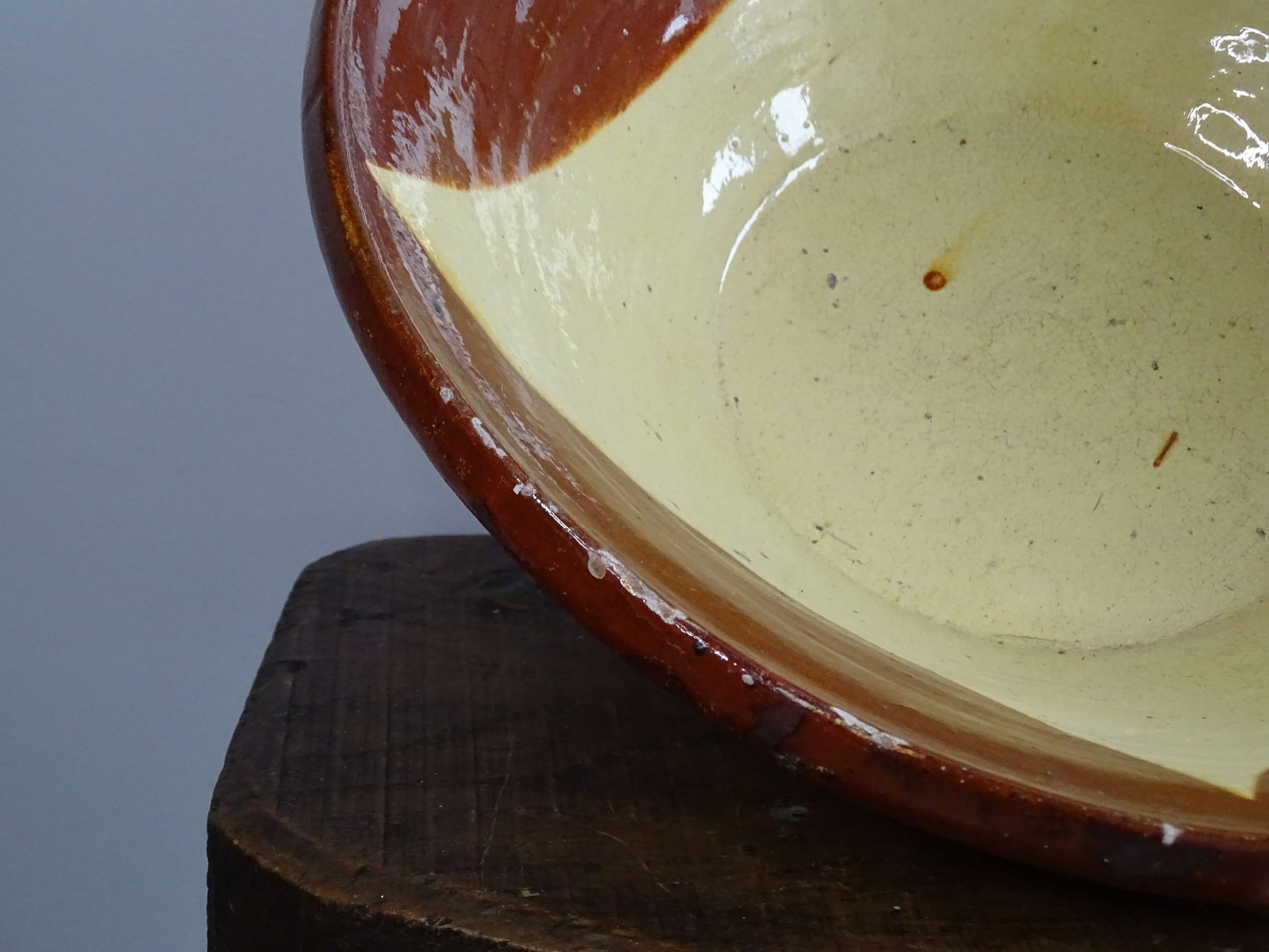 Spanish antique terracotta bowl or basin with a brown and yellow glaze to the interior. This pottery bowl has a timeworn patina.